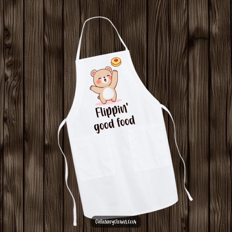 Funny apron showing a cute bear character in the midst of flipping a pancake, perfect for a playful cook.