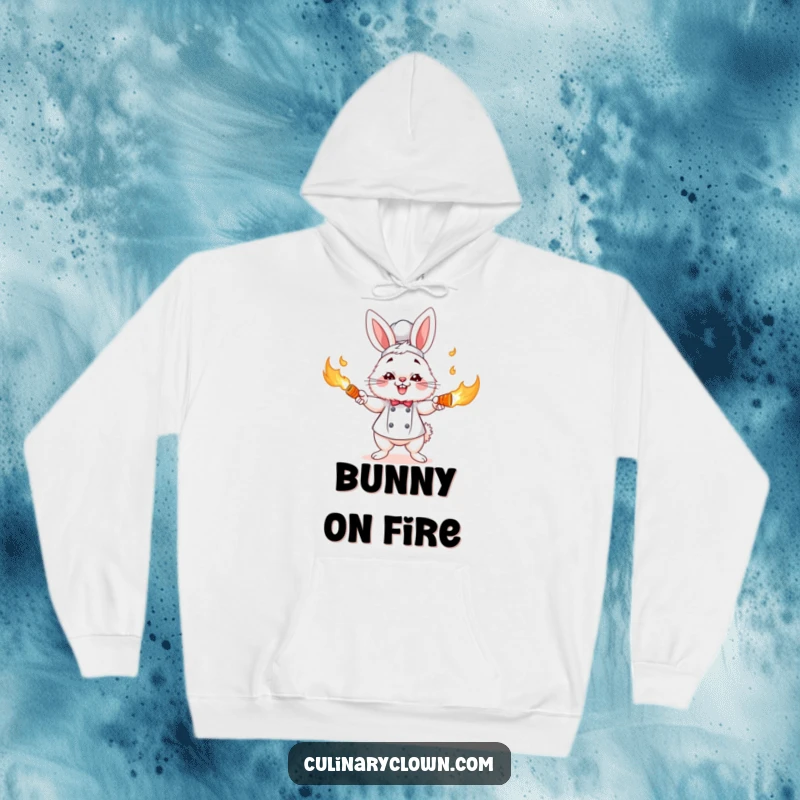 Funny fluffy bunny chef character focused on juggling burning carrots, featured on a warm hoodie, a great funny gift.