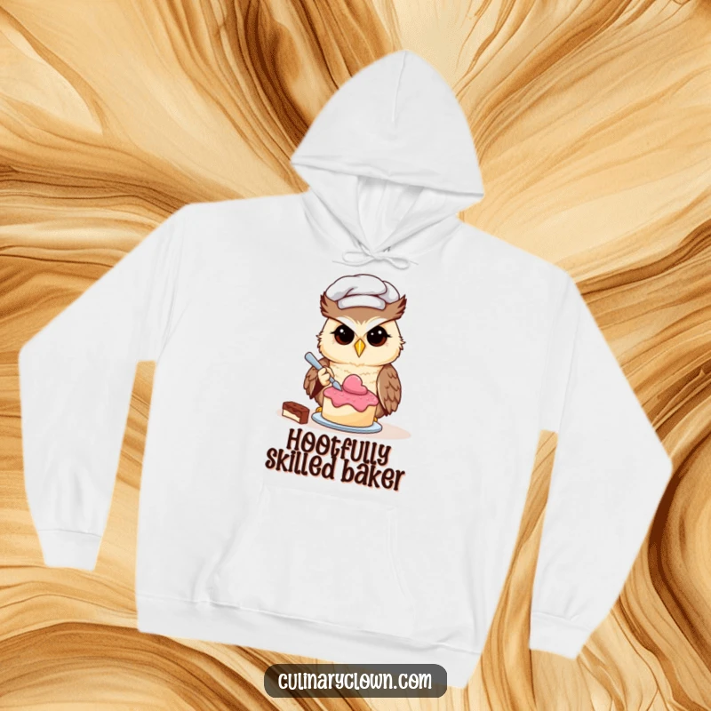 Funny owl chef character focused on decorating a tiny cake, warm and comfortable hoodie.