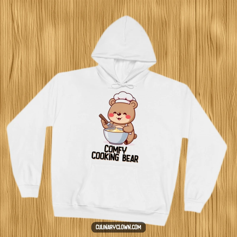 Funny hoodie design of a cheerful bear chef vigorously whisking batter in a bowl, ready to bake.
