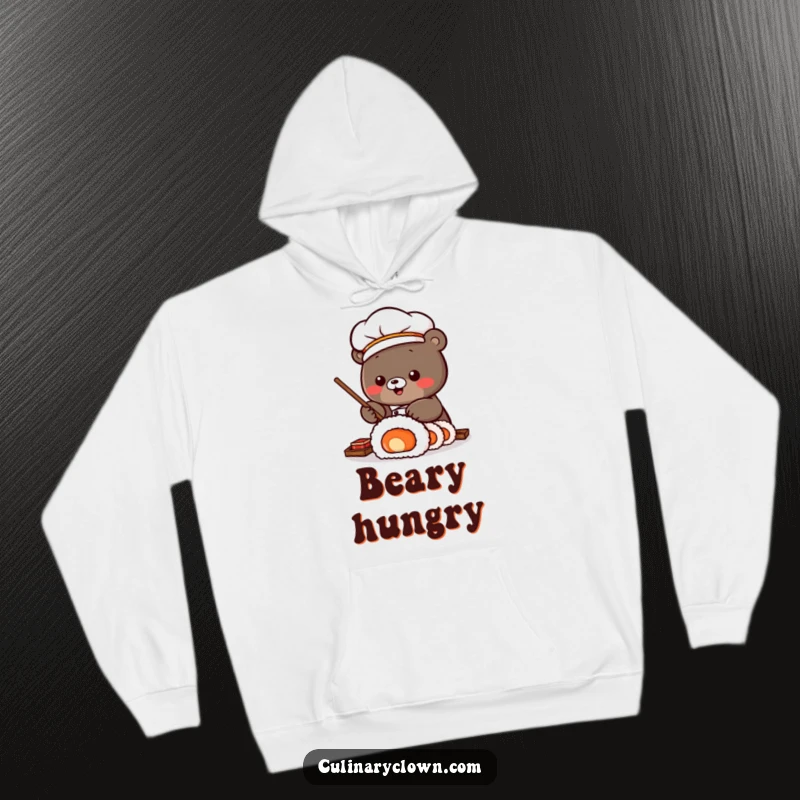 Funny Hoodie featuring a Kawaii bear sushi chef expertly rolling a large sushi roll, offering warmth and a touch of culinary humor.