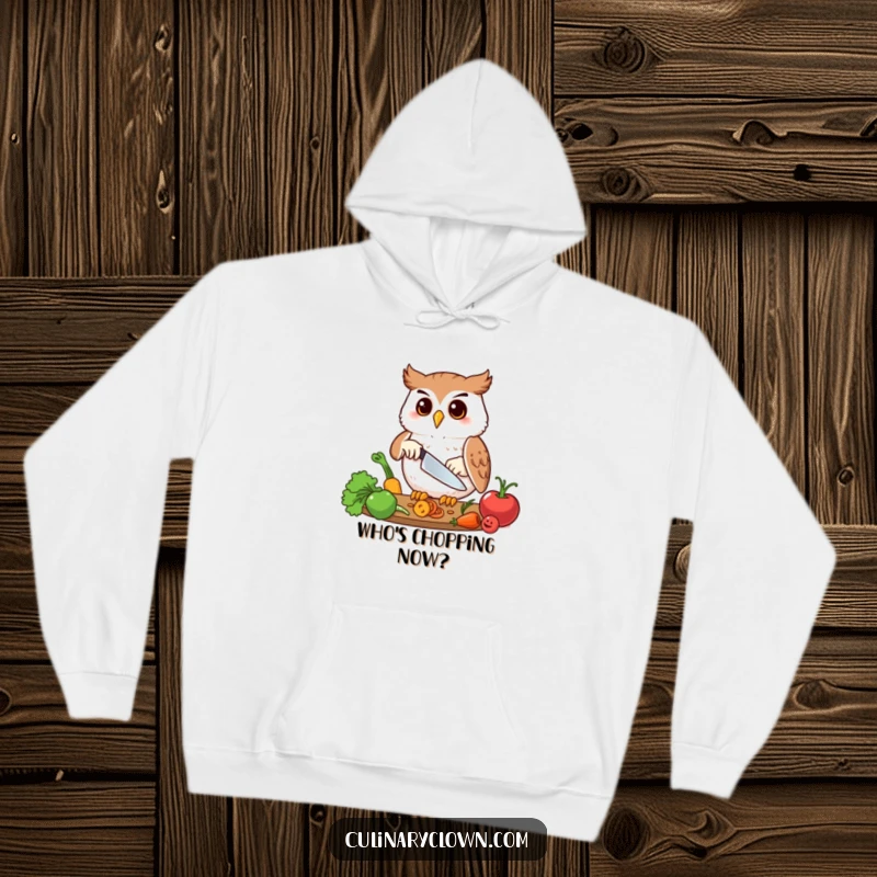 Funny hoodie with a happy owl character precisely chopping vegetables, perfect for cozy culinary sessions.