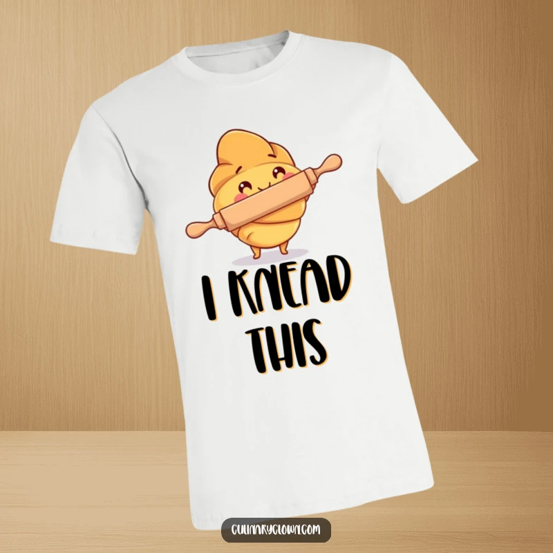 Funny T-Shirt of a happy croissant character focused on using a rolling pin, celebrating the art of baking.