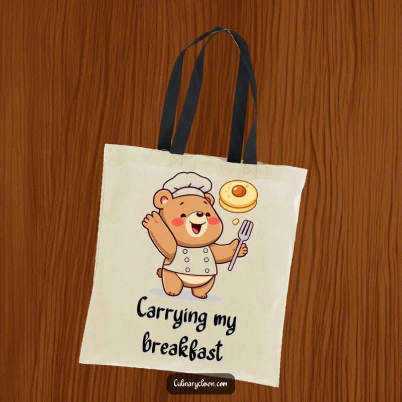 Funny tote bag with a happy bear chef tossing a pancake in the air, perfect for carrying breakfast goodies.