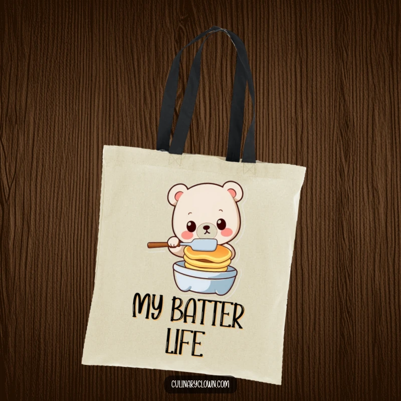 Funny kawaii bear character juggling pancakes and a spatula on a tote bag, ideal for a humorous shopper.